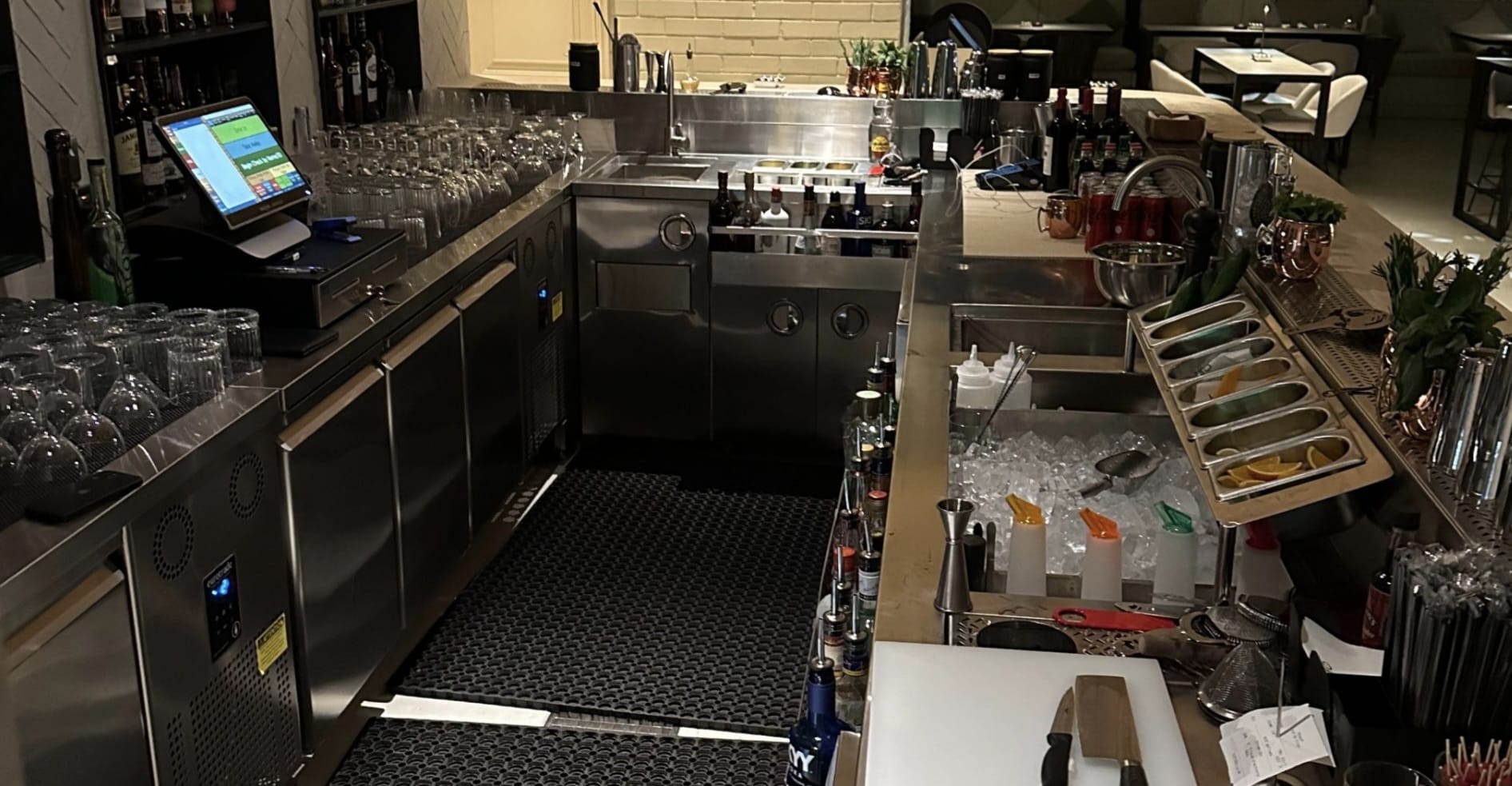 Back bar with undercounter refrigeration, glassware and ice well in a restaurant bar