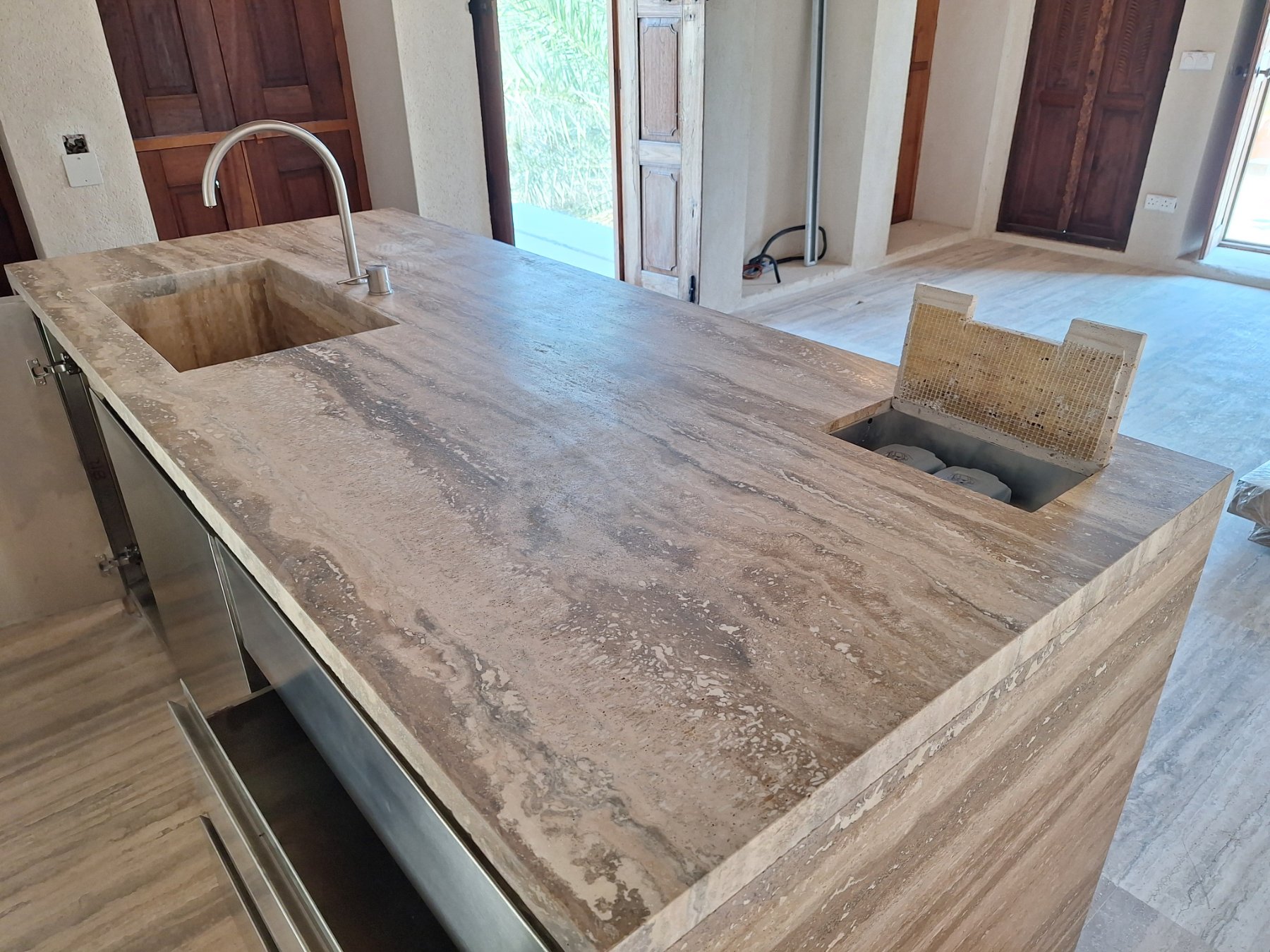Travertine kitchen island top with integrated sink, tap and recessed access box