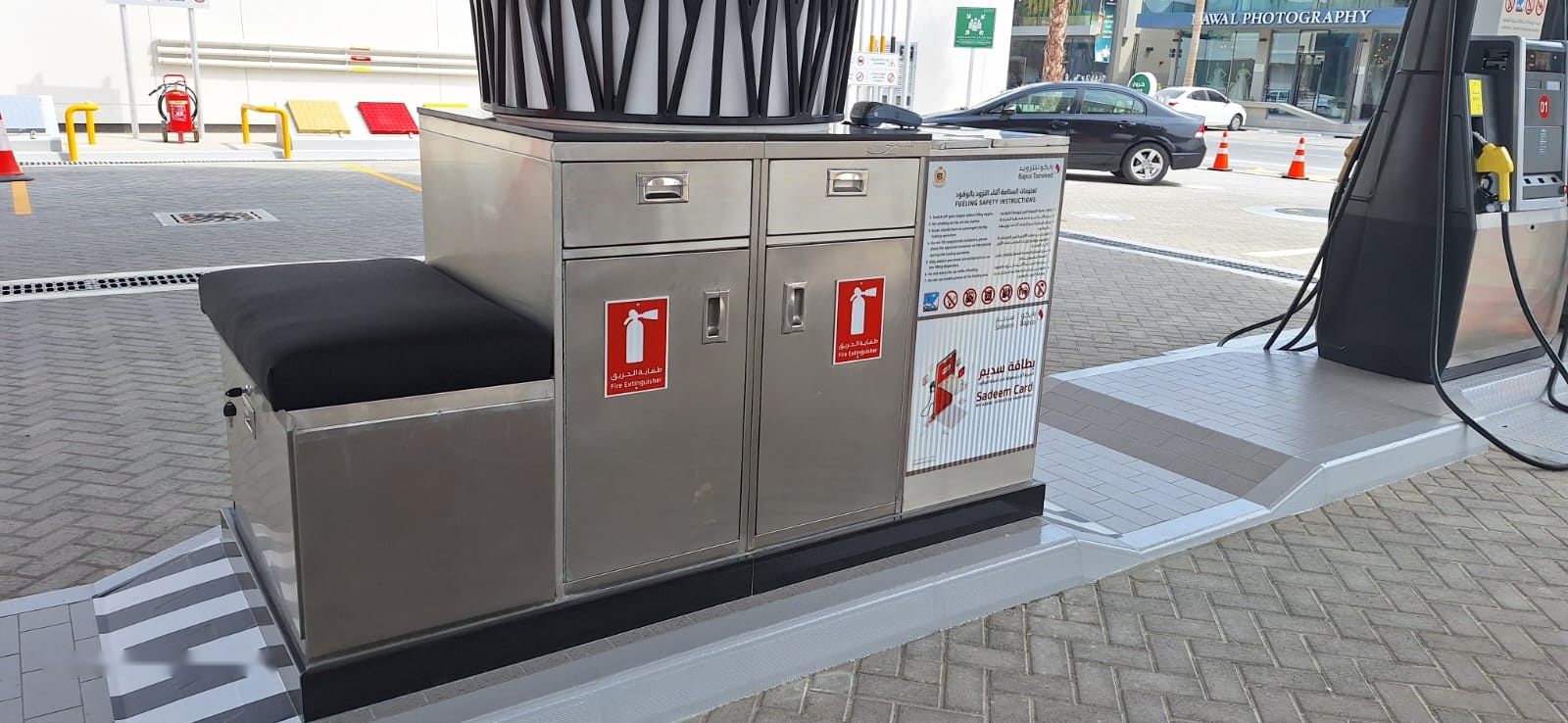 Fuelling-island cabinets with two fire extinguisher doors, drawers, safety panel and seat at a petrol station