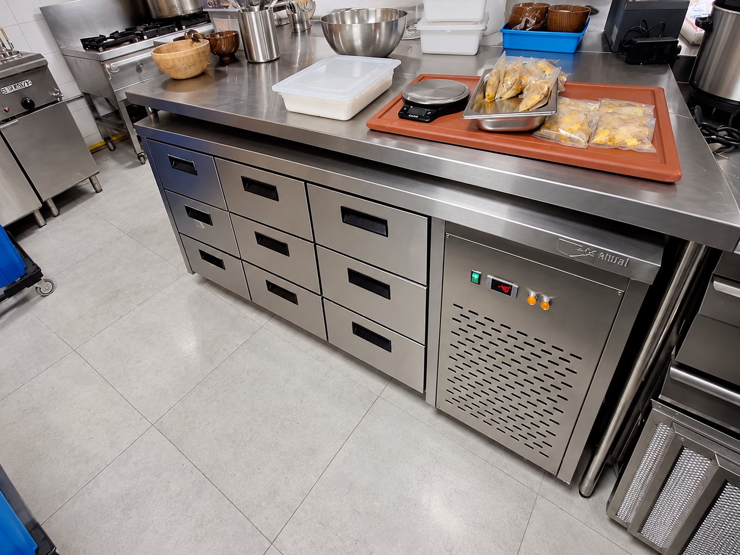 Awal refrigerated drawer counter with digital temperature display in a restaurant kitchen